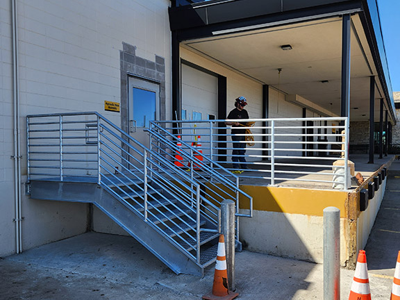 Worker installing platform railings