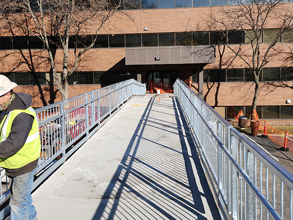 Worker installing walkway railings