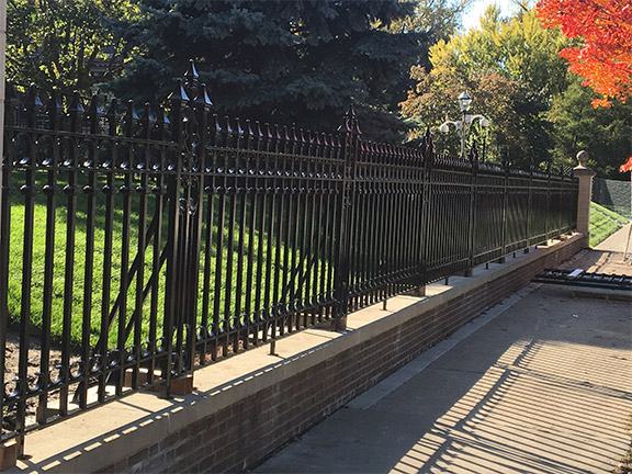 Metal fence on stone wall